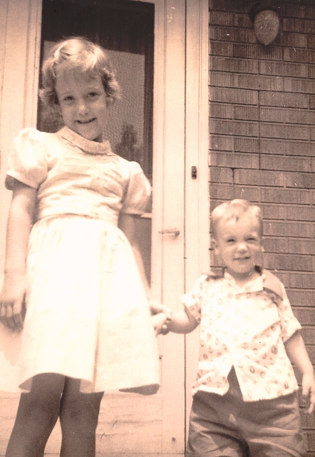My brother and me circa 1959 standing outside my grandparents' back door.