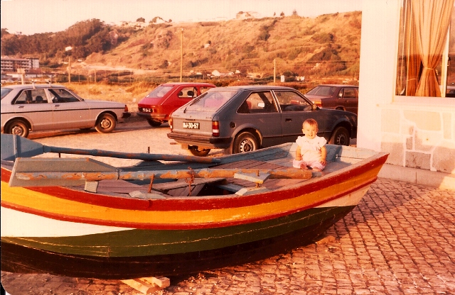 Susie in one of the colorful fishing boats in Nazaré.